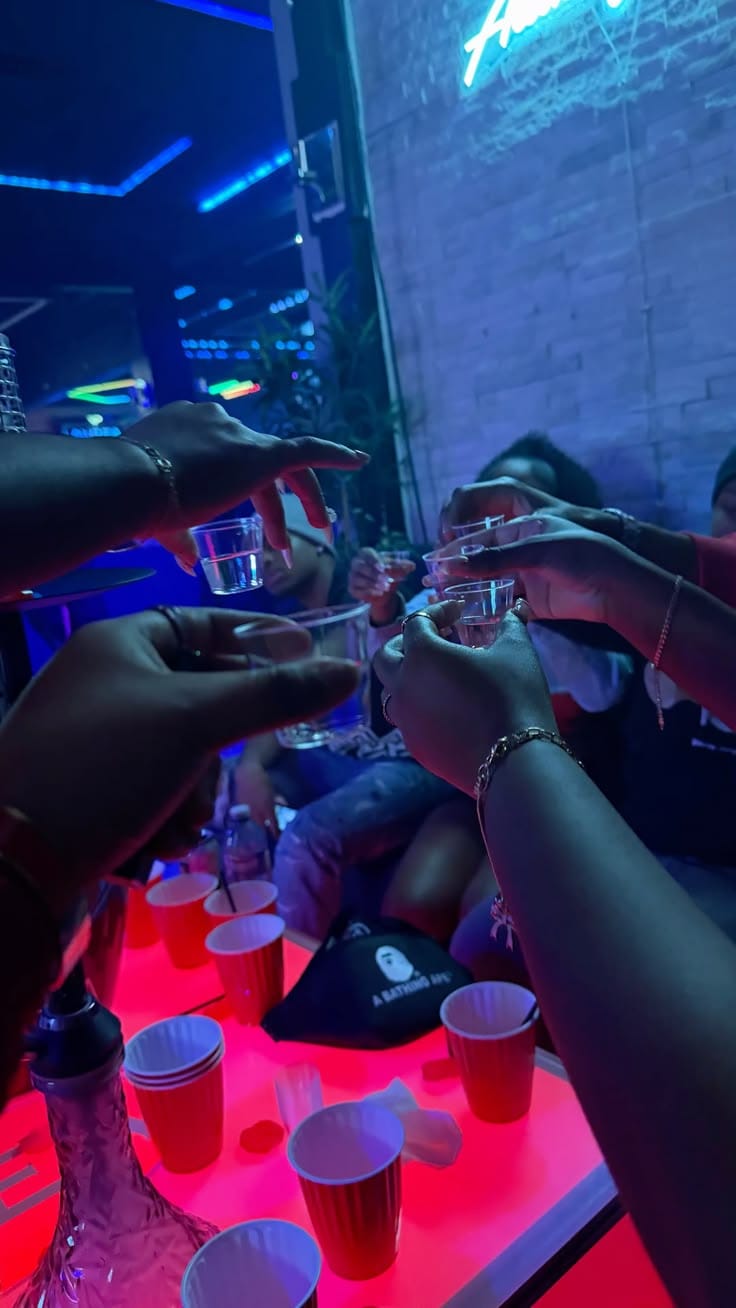 Friends toasting shot glasses on a night out