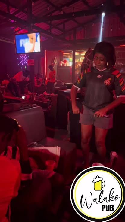Guest dancing in a football jersey on match night