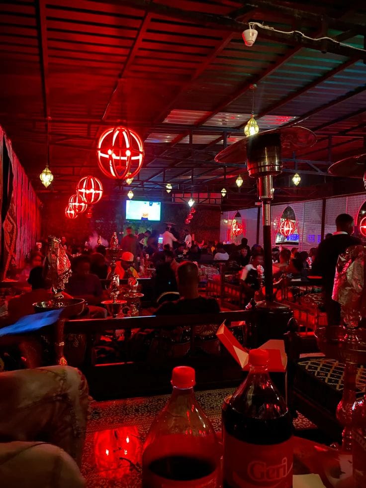 Red-lit shisha lounge seating at Walako Pub